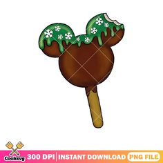 a mickey mouse lollipop with green icing on it's head and snowflakes