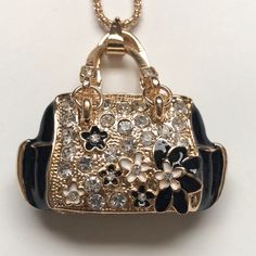 White Crystal Flower Purse Color: Black, White & Gold Chain: 14” Pendant: W: 2” L: 2” Chic Black Jewelry For Everyday Use, Chic Black Everyday Jewelry, Elegant Black Necklace For Everyday Use, Crystal Purse, Flower Purses, White Gold Chain, White Gold Chains, Black White Gold, Vintage Jewels