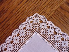 a white doily sitting on top of a wooden table