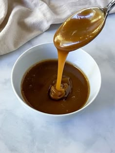 caramel sauce being poured into a white bowl with the words easy salted caramel sauce