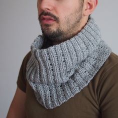 a man with a beard wearing a knitted cowl neckwarmer in grey