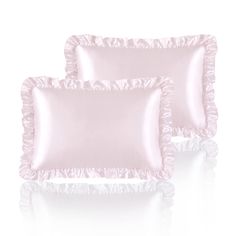 two pink satin pillows with ruffles on the bottom and one pillow in the middle