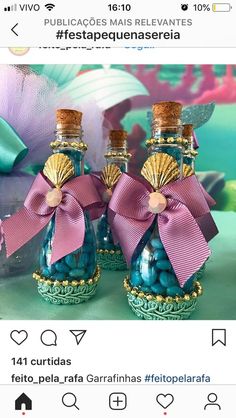 two blue bottles with pink bows on them