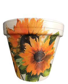 a flower pot with sunflowers painted on it