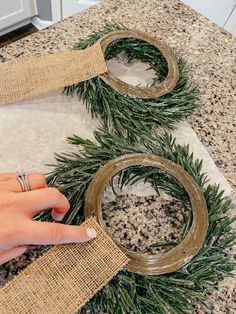 someone is making wreaths out of burlock and twine with their fingers