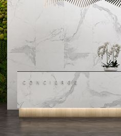 a white marble reception desk with flowers on it