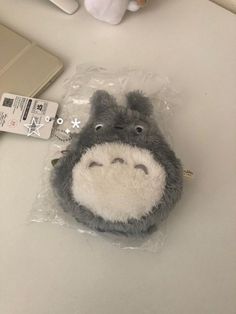 a stuffed animal in a plastic bag next to a laptop