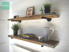 two wooden shelves with books and plants on them