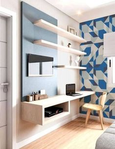 a bedroom with blue and white geometric wallpaper, a bed, desk and chair