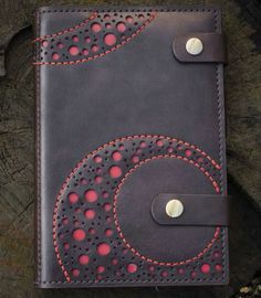 a handmade leather journal with red stitching