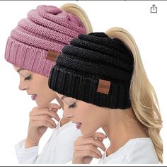 two women with ponytails wearing knit hats