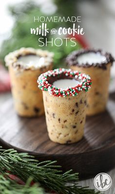 homemade milk and cookie shots with sprinkles in them on a wooden tray