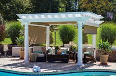 an outdoor living area next to a swimming pool