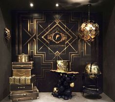 a room filled with lots of gold and black furniture next to a wall covered in art deco