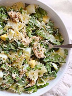 a white bowl filled with pasta and vegetables