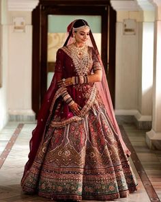 a woman in a red and gold bridal gown