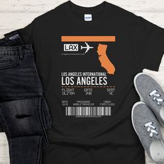 Introducing our remarkable LAX Airport Graphic T-Shirt, a perfect fusion of style and travel enthusiasm. This stunning t-shirt showcases a detailed graphic representation of the renowned Los Angeles International Airport (LAX), capturing the essence of this bustling travel hub in all its glory. Whether you're a seasoned globetrotter, an aviation aficionado, or simply appreciate the beauty of iconic landmarks, our LAX Airport Graphic T-Shirt is a must-have addition to your wardrobe. It's not only a fashion statement but also a symbol of your love for travel, aviation, and the unforgettable experiences that airports like LAX provide. Choose this extraordinary t-shirt to express your passion for exploration, showcase your individuality, and carry a piece of the vibrant airport atmosphere wher Black Crew Neck T-shirt For Travel, Los Angeles Airport, Travel Memorabilia, Lax Airport, Los Angeles International Airport, Travel Tees, Air Travel, Travel Inspired, Iconic Landmarks