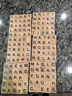 two scrabble tiles with words on them sitting on a marble counter top next to each other