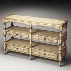 an old white wooden shelf with drawers