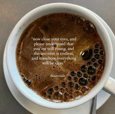 a cup of coffee with a quote about how close your eyes, and please understand that you are still young, and the universe is endless, and somehow everything will be okay