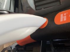 an orange and white blow dryer sitting on top of a table