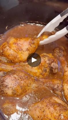 chicken being cooked in a pot with a spatula