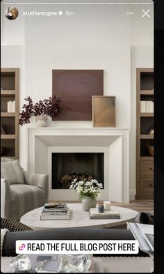 a living room filled with furniture and a fire place in front of a book shelf