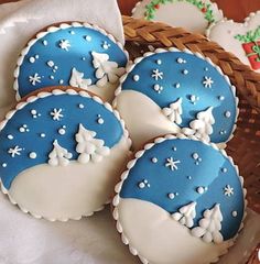 four decorated cookies in the shape of snowflakes