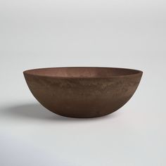 a brown bowl sitting on top of a white table