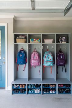 A modern garage mudroom with sleek, dark cabinetry, hooks, and a bench for stylish storage. Gray Mudroom, Garage Lockers, Mudroom Ideas Diy, Laundry/mudroom Ideas, Kids Garage, Functional Mudroom