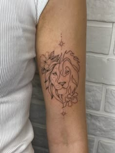 a woman's arm with a small tattoo of a lion on the left side