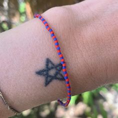 matte red and blue seed bead bracelet strung on elastic please gently roll on and off to prolong its life handmade in venice, ca Adjustable Red Friendship Bracelets With Spacer Beads, Adjustable Red Friendship Bracelets, Adjustable Red Heishi Beads Friendship Bracelets, Red Friendship Bracelets With Colorful Beads For Festival, Red Heishi Beads Friendship Bracelets, Red Beaded Stretch Bracelet For Festival, Red Hand Wrapped Beaded Bracelets For Beach, Red Hand-wrapped Beaded Bracelet For The Beach, Red Hand Wrapped Beaded Bracelet For Beach