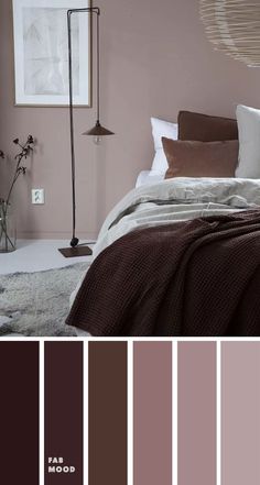 a bed room with a neatly made bed and some brown accents on the headboard