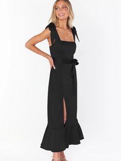 Make a daring statement in our AVIANCA Shoulder Tie Bridal Midi Dress in Black. This alluring bridal inspired midi dress features the signature AVIANCA shoulder tie detailing and rich claret fabric with a delicate shimmer, creating a sophisticated and exclusive look for the fashion-forward bride. Crafted with a luxurious feel, this dress is sure to dazzle on your special day or wedding guests. Size Guide: Model is 5’6” tall, and has a 33.4” bust, 26.5” waist, & 34.6” hips. She is wearing a S / U Fitted Bridesmaid Midi Dress With Tie Back, Bridesmaid Midi-length Dress With Tie Back, Bridesmaid Midi Dress With Tie Back, Black Party Dress With Tie Straps, Chic Evening Maxi Dress With Tie Straps, Black Square Neck Dress For Wedding, Fitted Midi Length Dress With Tie Straps, Fitted Black Dress With Tie Back, Sleeveless Black Maxi Dress With Tie Straps