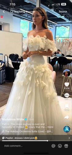 a woman in a white wedding dress is taking a selfie