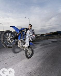 a man flying through the air while riding a dirt bike