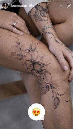 a woman's leg with flowers on it