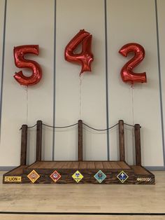 the number 542 balloons are on display in this room