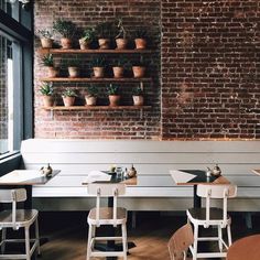 an empty restaurant with white tables and chairs