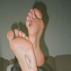 a person with their feet up in the air while holding onto another persons hand and foot