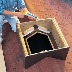 a man is sitting on the roof with tools