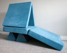 a blue bench sitting on top of a carpeted floor