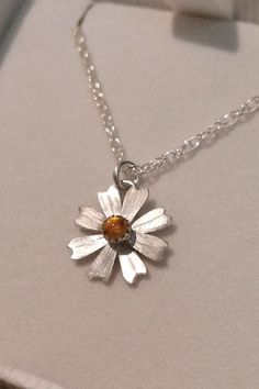 Simple and sweet, this dainty daisy flower necklace glows bright with golden citrine where each petal is hand-sculpted from sterling silver, textured, and soldered together to form this precious hand-crafted necklace. Dainty Daisy Sterling Silver Jewelry, Sterling Silver Flower Birthstone Necklaces, Sterling Silver Flower Birthstone Necklace, Sterling Silver Flower Shape Birthstone Necklaces, Sterling Silver Flower-shaped Birthstone Necklaces, Sterling Silver Birthstone Necklace In Flower Shape, Sterling Silver Flower Shape Birthstone Necklace, Delicate Sterling Silver Round Flower Necklace, Delicate Citrine Jewelry For Gifts