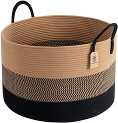 a large basket with black handles and tan stripes on it's sides, has a tag hanging from the handle