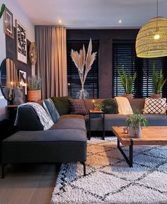 a living room filled with lots of furniture next to a window covered in shades of brown