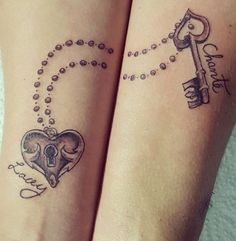 two people with matching tattoos on their legs, one has a key and the other has a heart