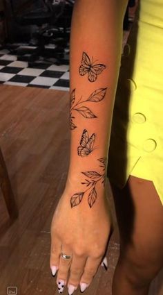 a woman's arm with butterflies on it