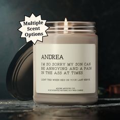 a candle that is sitting on a table next to the words and sayings above it