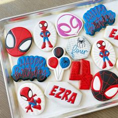 decorated cookies in the shape of superheros on a tray