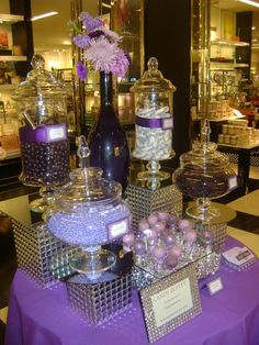 a purple table topped with lots of different types of candies